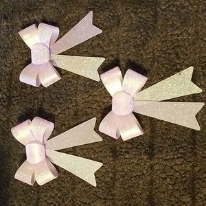 Set of three sparkly, glittery, purple bows.